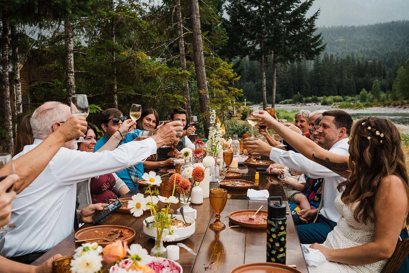 Guests raise their glasses for toasts at a small micro wedding dinner in Washington. 