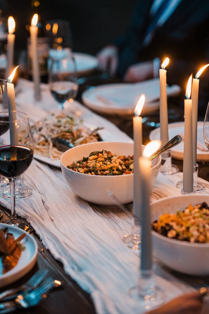 Candlelit dinner table with food and wine at a small wedding reception in Washington.