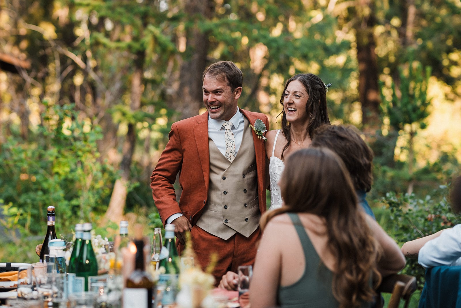 Bride and groom laugh while addressing their guests during their small wedding reception in Washington. 