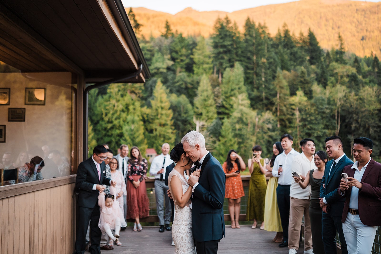 Bride and groom slow dance on a deck at their state park wedding venue in the North Cascades. 