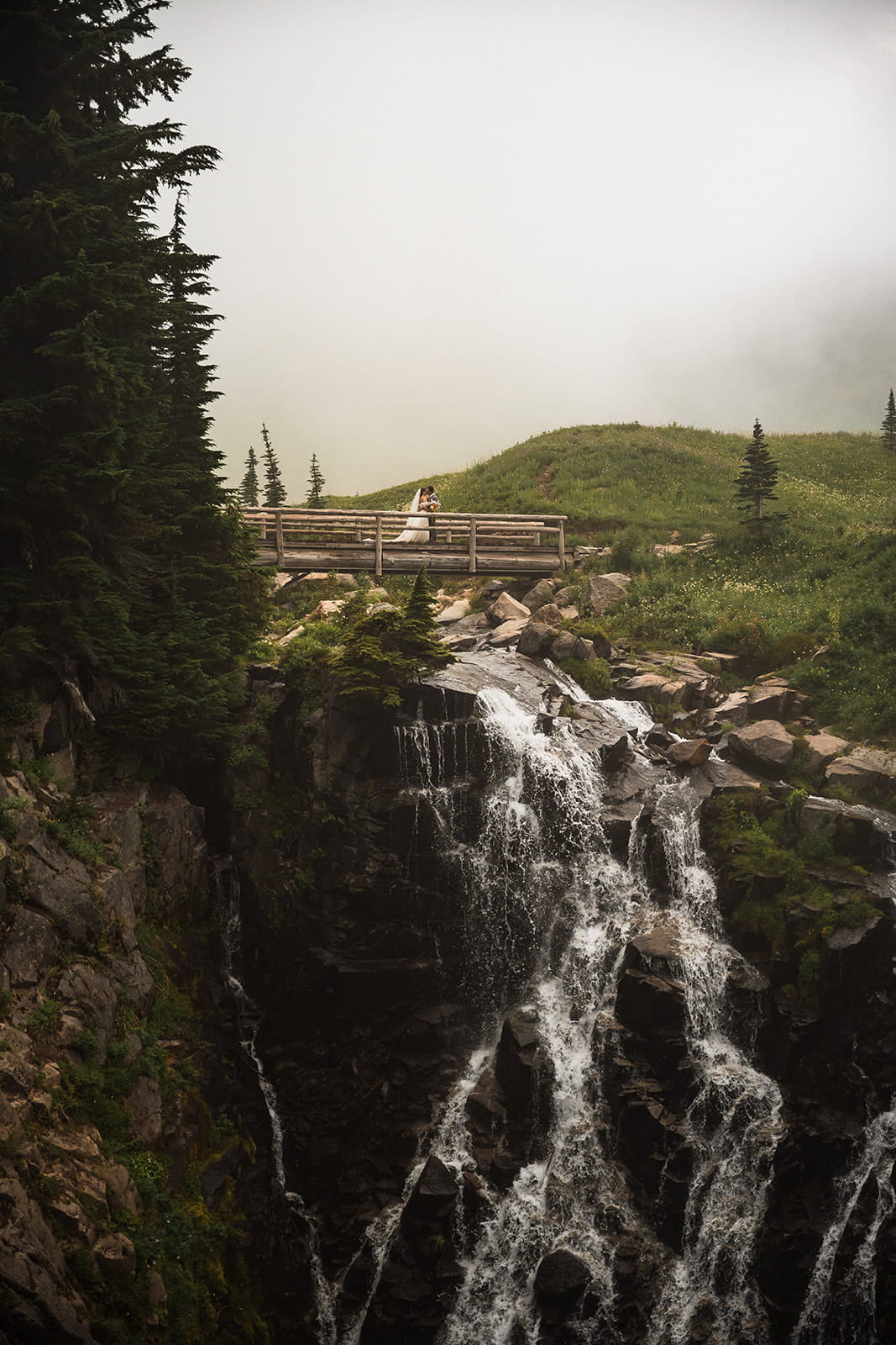 Bride and groom kiss on top of Myrtle Falls at Mt Rainier National Park. 