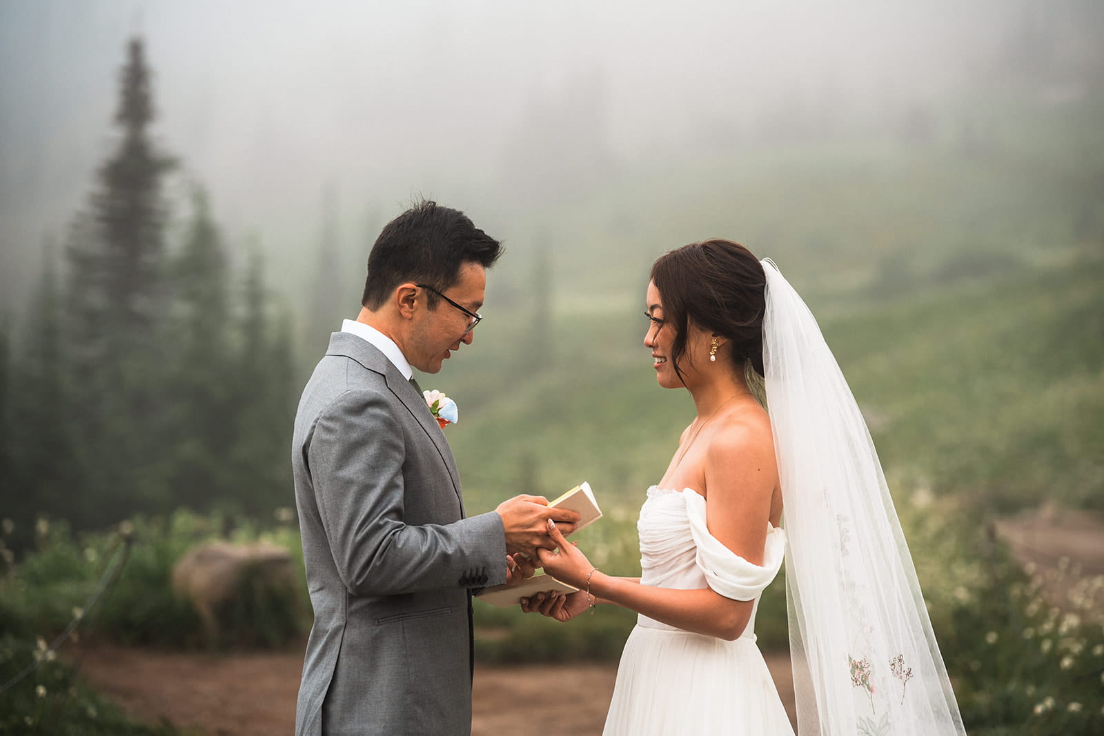 Bride and groom exchange private vows during their foggy elopement  in Washington.