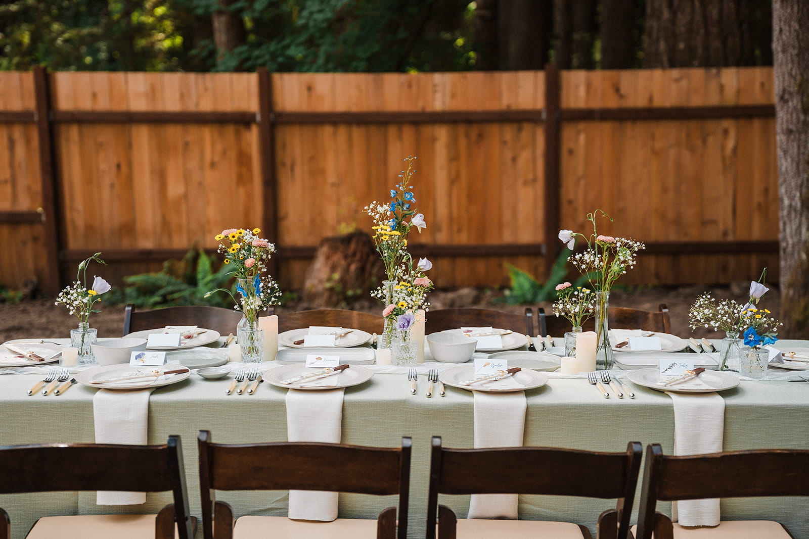 Sage green and wildflower themed forest wedding reception table decor.