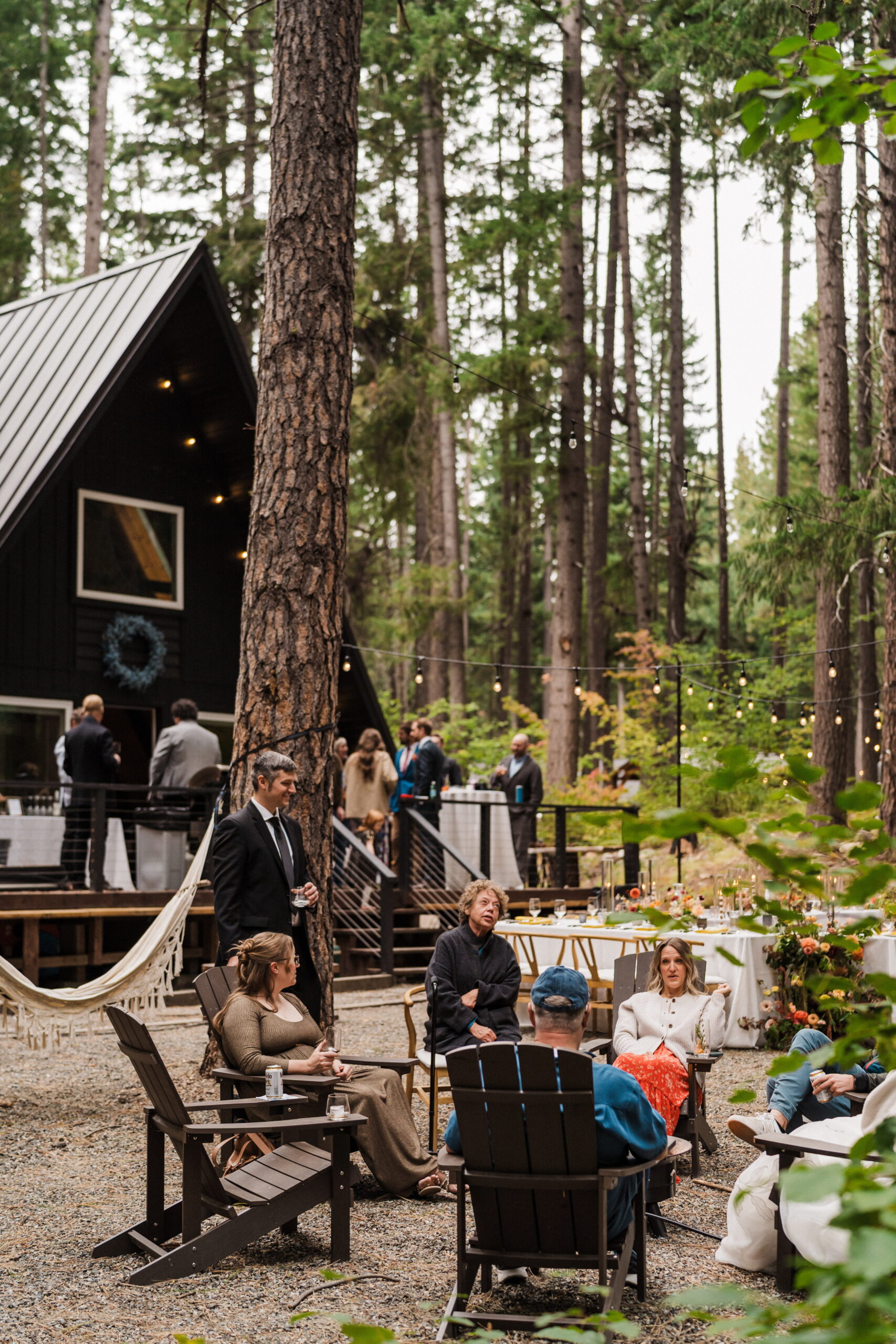 Guests mingle during cocktail hour at an A-frame cabin in Washington. 