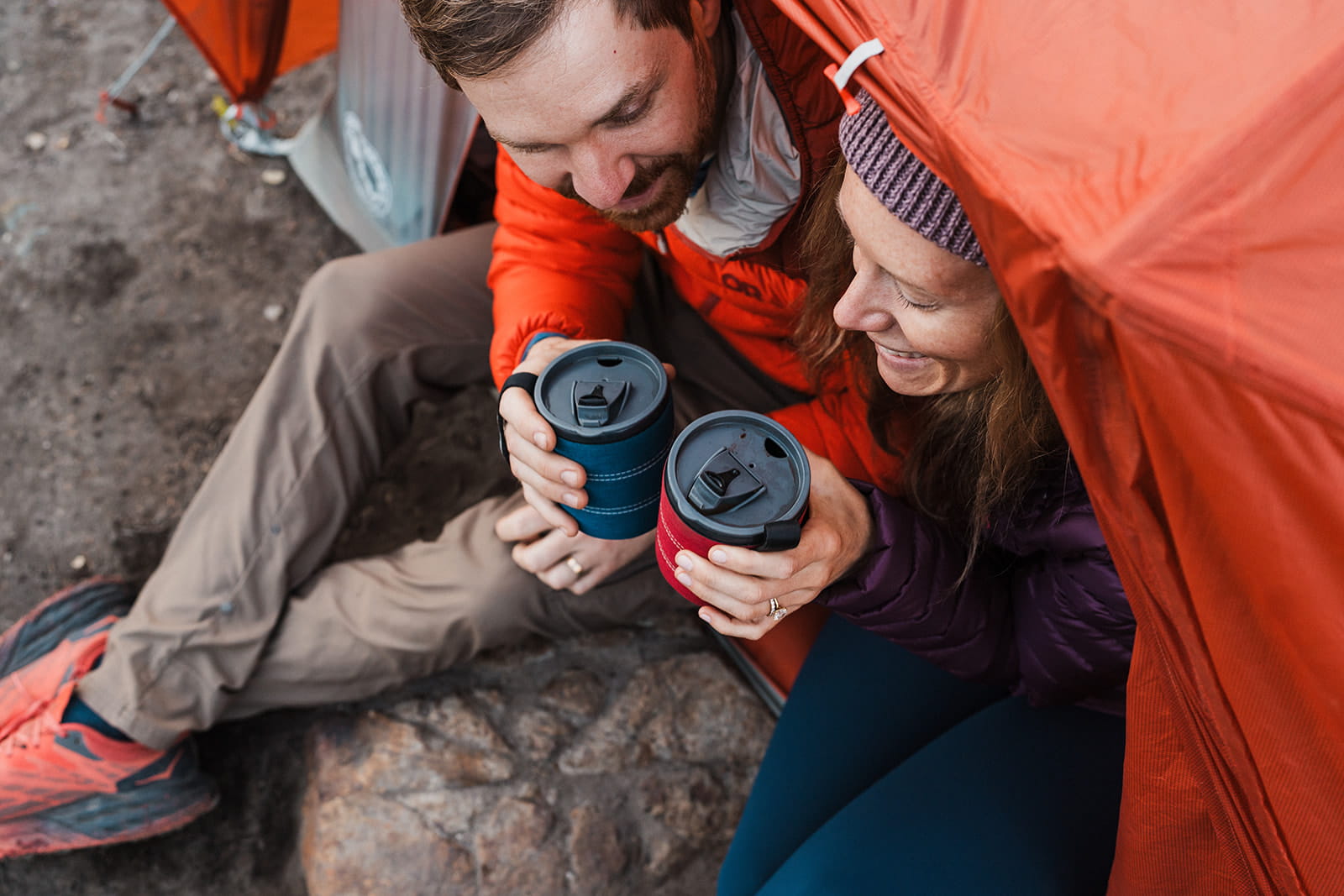 Couple drinks coffee during their sunrise backpacking elopement at Snow Lake Trail. 