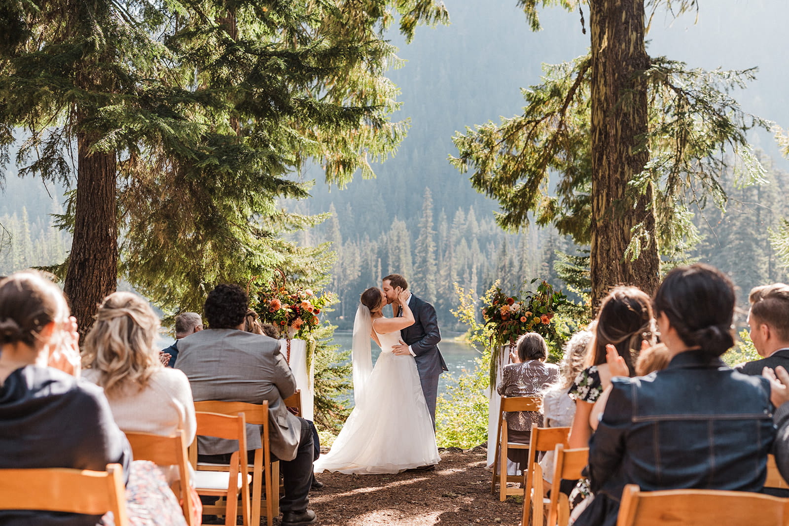 Bride and groom kiss during their intimate wedding ceremony at Cooper Lake. 