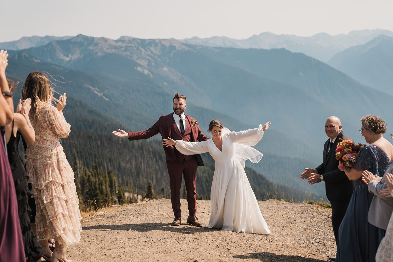 Guests clap for newlyweds after their intimate wedding ceremony in Olympic National Park.