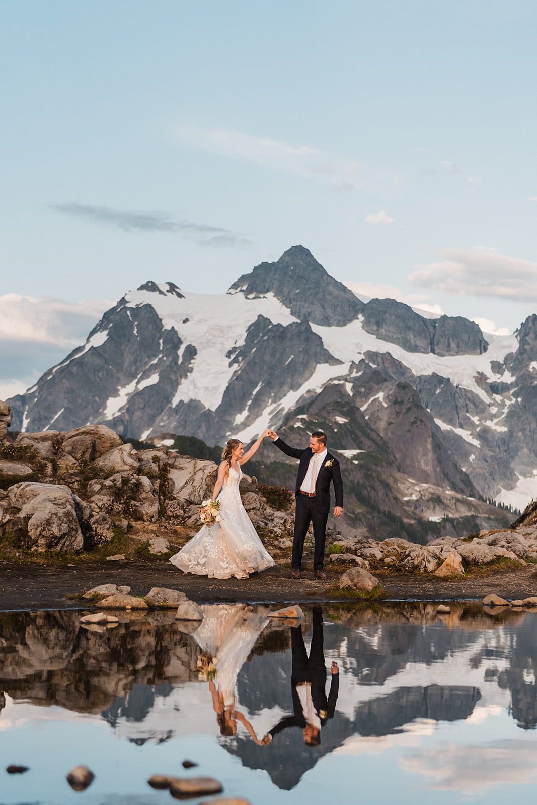 Newlyweds dance in front of a reflection lake at Huntoon Point during their full day elopement photography package.