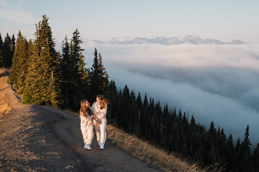 Two women hike down a mountain trail in Olympic National Park.