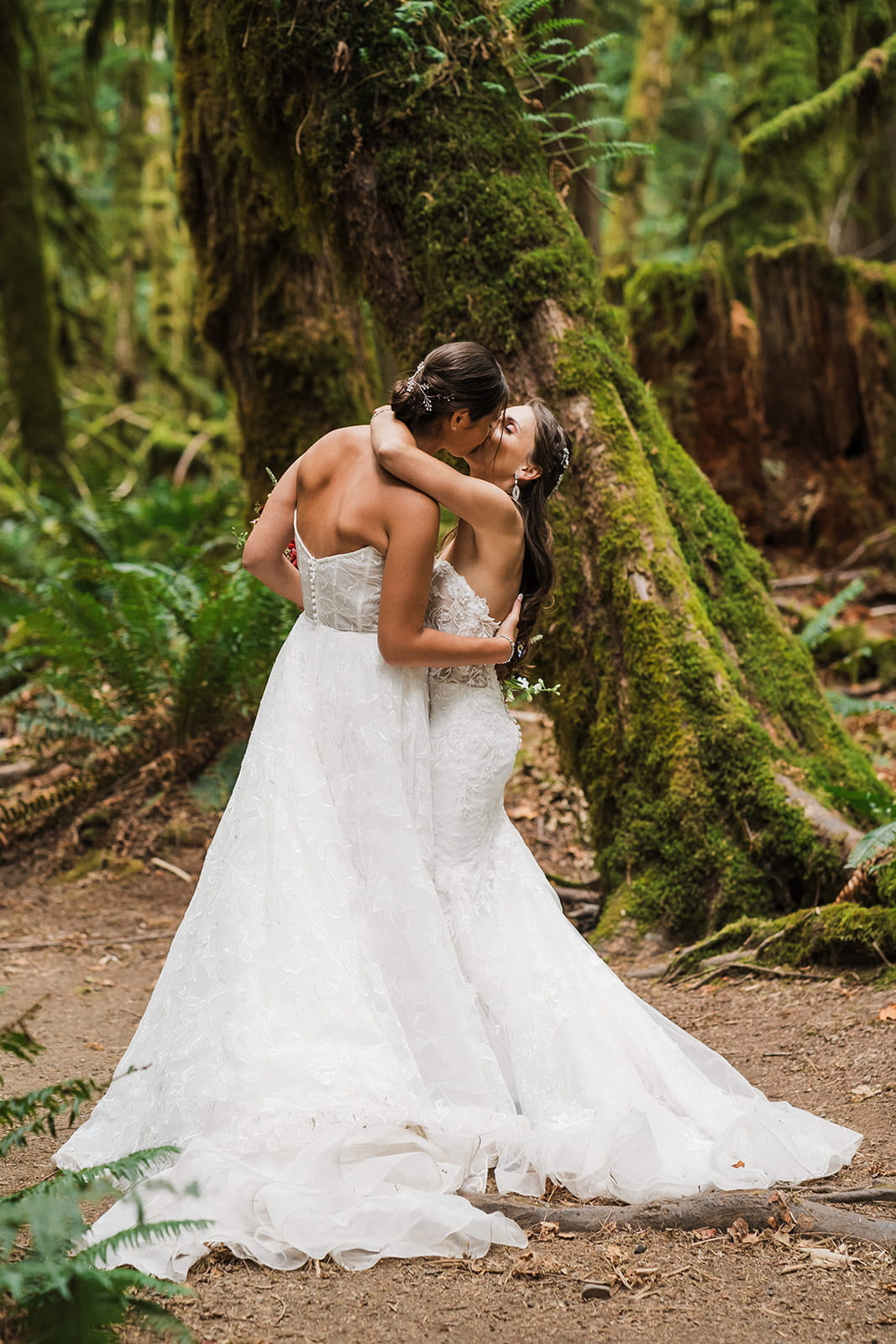 Brides kiss in the forest during their Port Angeles elopement.