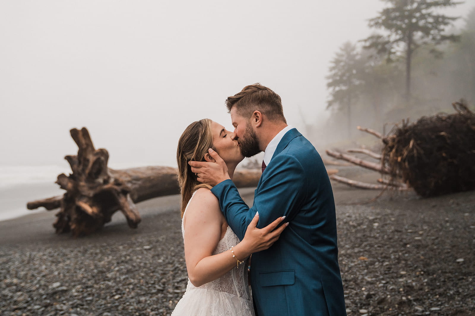 Newlyweds kiss on Rialto Beach during their full-day elopement on the Olympic Coast.